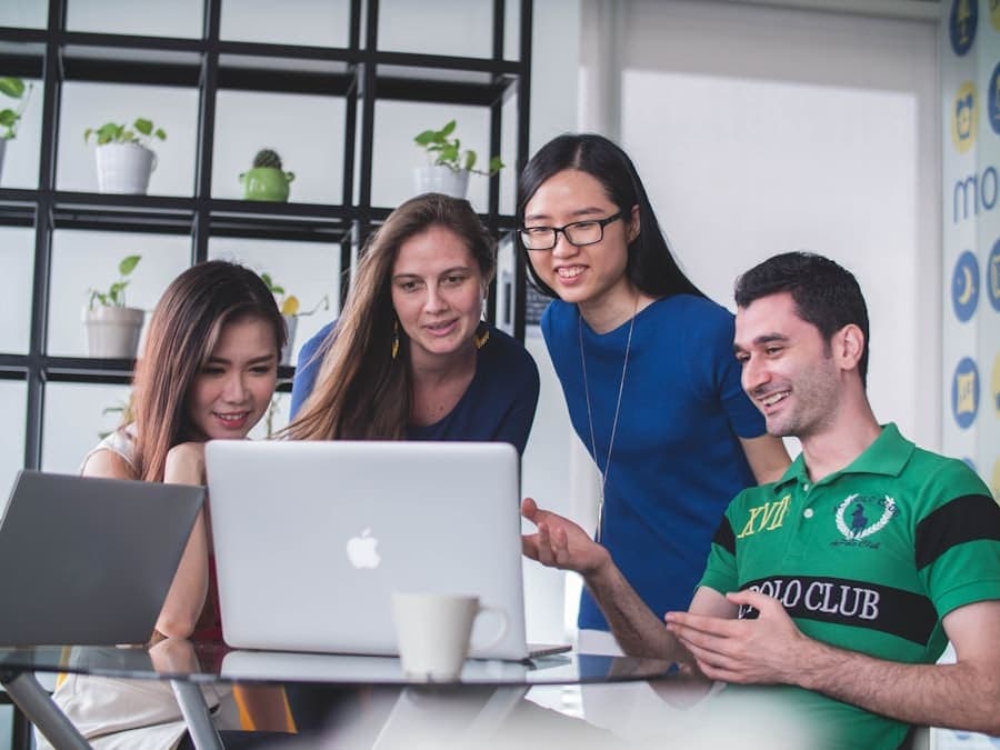 A small group working through something together on a laptop