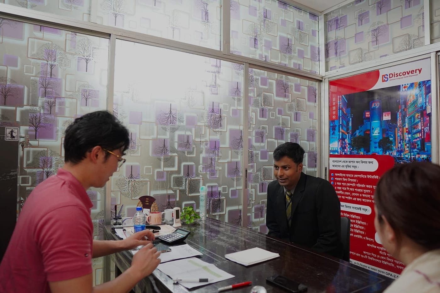 A counseling session at the Discovery center in Dhanmondi, with papers and an open notebook on the desk