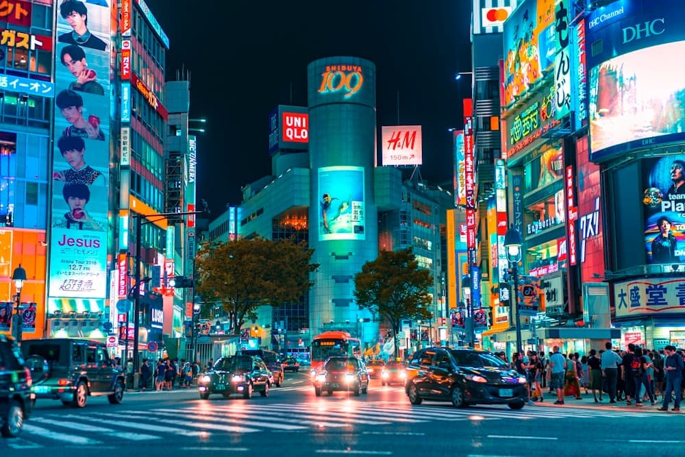 A busy city crossing in Japan at night